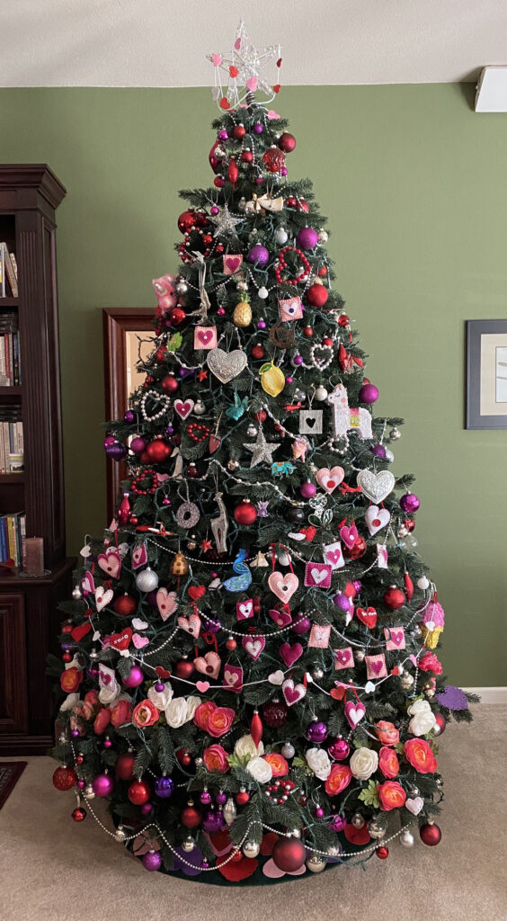 holiday tree with heart and luck symbols