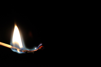 Match stick burning out with a black background